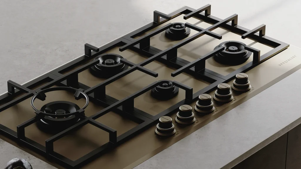 Spezialist 5 burner cooktop with brushed brass finish installed on a light coloured bench top