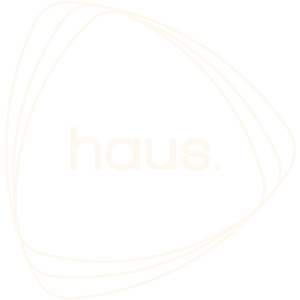 Haus Group primary logo ivory on dark background